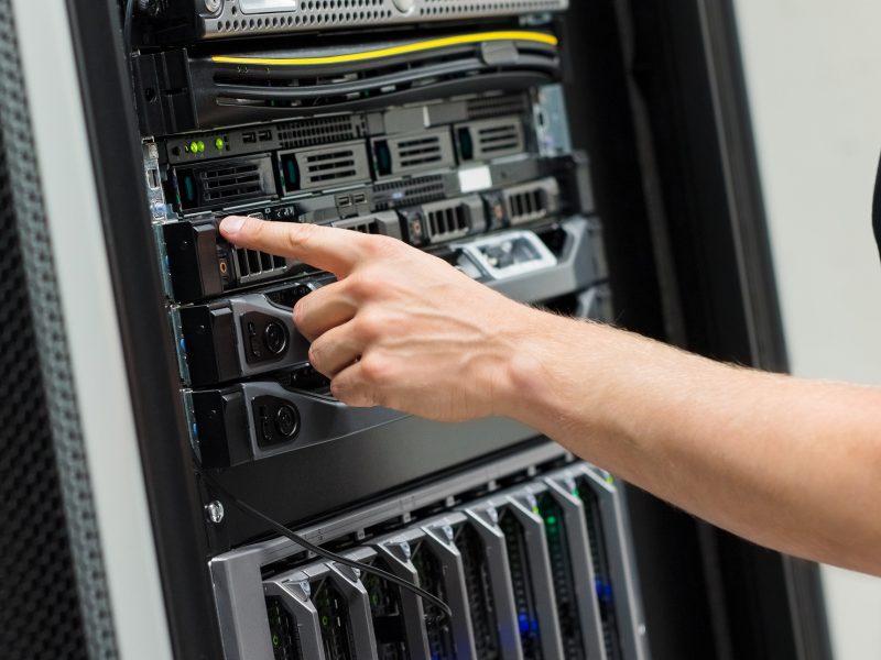 Close-up of IT Engineer Switching On Server At Datacenter Close-up of IT Engineer Switching On Server At Datacenter